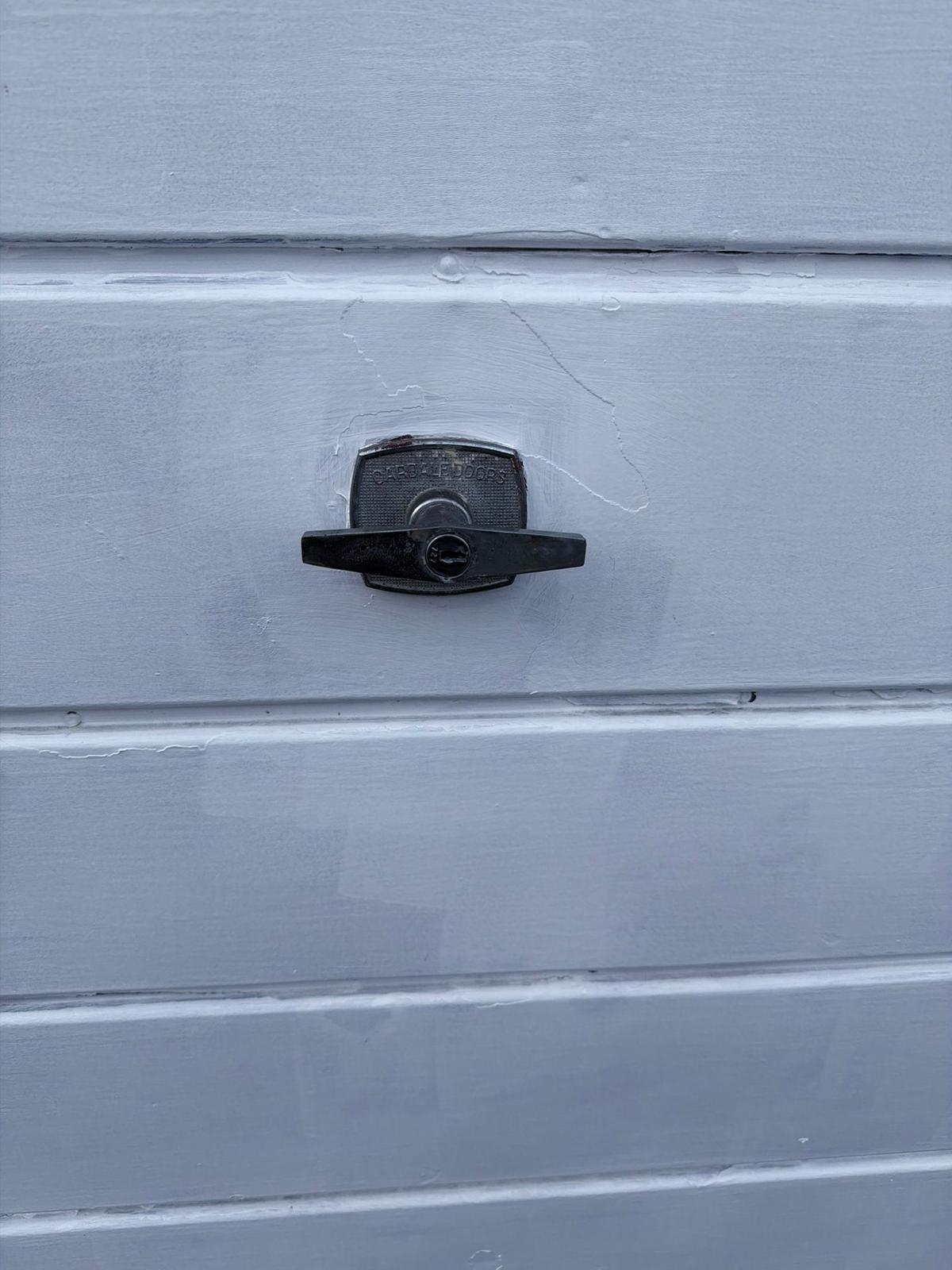 Garage door lock cylinder and handle